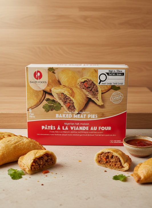 Box of baked meat pies with a red label on a dark surface