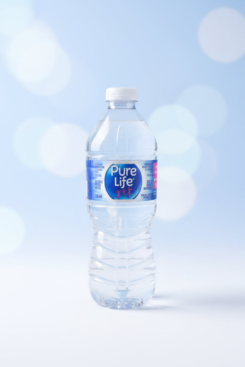A clear plastic bottle of Pure Life water with a blue and white label, lying horizontally on a white shelf with other green bottles in the background.