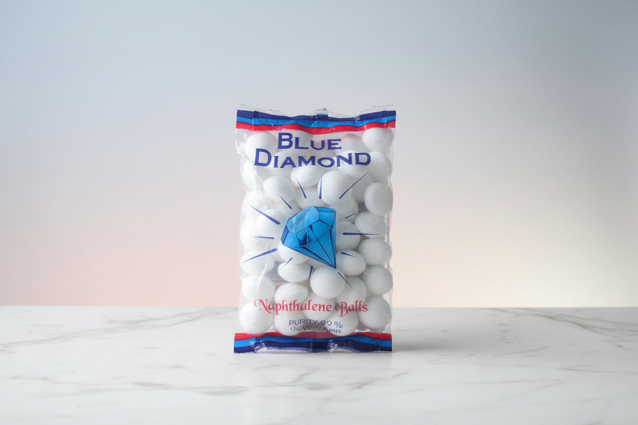 Packaged Blue Diamond naphthalene balls on a wooden surface