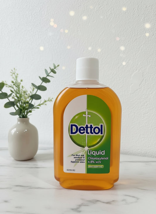 Dettol liquid hand wash bottle on a marble surface with a blurred festive background
