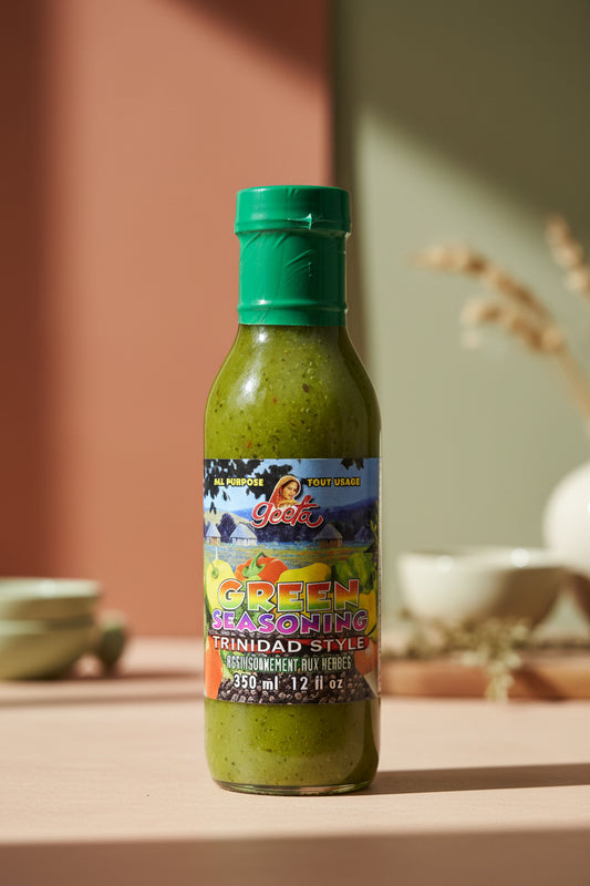 Bottle of green seasoning on a table with a blurred background