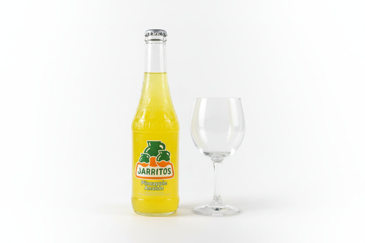 Yellow bottle with Jarritos logo on a metallic surface