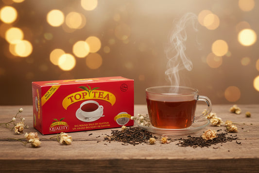 A red box of Top Tea instant coffee sachets resting on a white table in a domestic setting, with a water bottle and bathroom items blurred in the background.