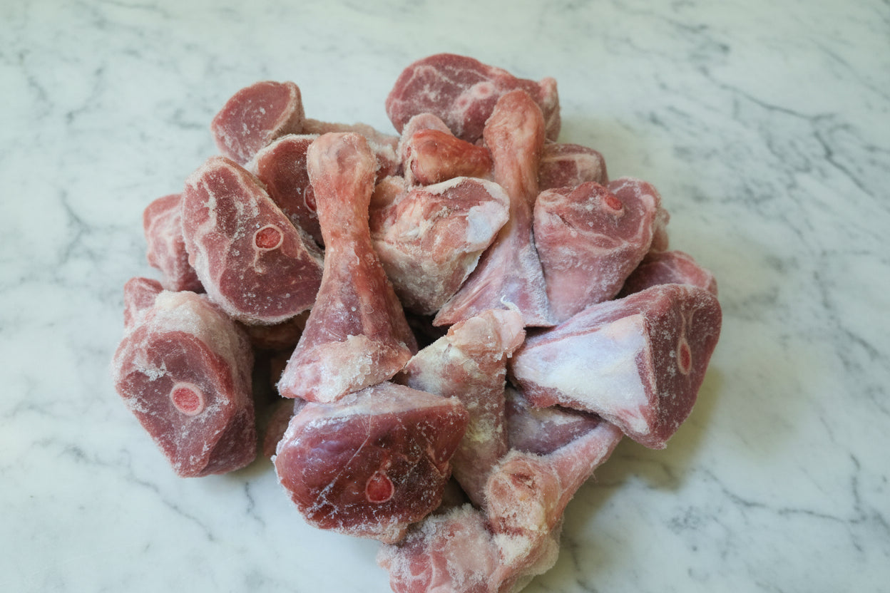 Frozen beef pieces on a marble surface