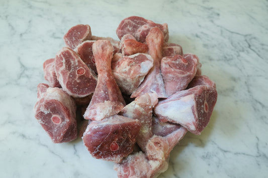 Frozen beef pieces on a marble surface