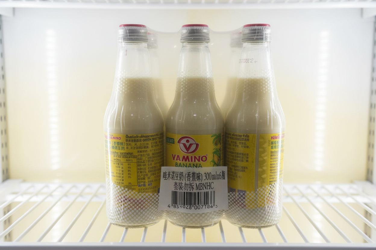 Three plastic bottles with yellow labels in a shopping cart.